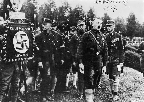 Hitler at the party Day held at Nuremberg in 1927. On the right is Franze Pfeffer von Salomon, SA commander.
