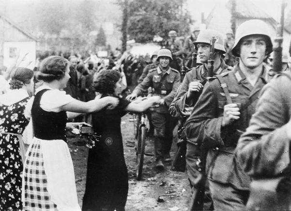 German troops receive a rapturous welcome as they march into the Sudetenland in September.