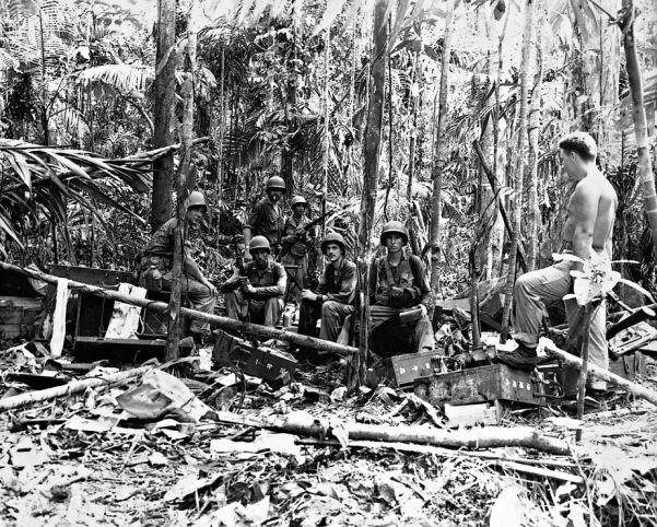 American troops pose for a photograph om a captured Japanese command post in the Solomons
