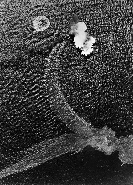 Twisting and turning in a desperate effort to escape, a Japanese destroyer is hit by bombs in the Bismarck Sea