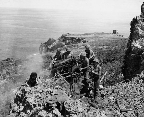 Same task, different island - flushing out Japanese defenders on Tinian, one of the Mariana Islands, with a pack howitzer